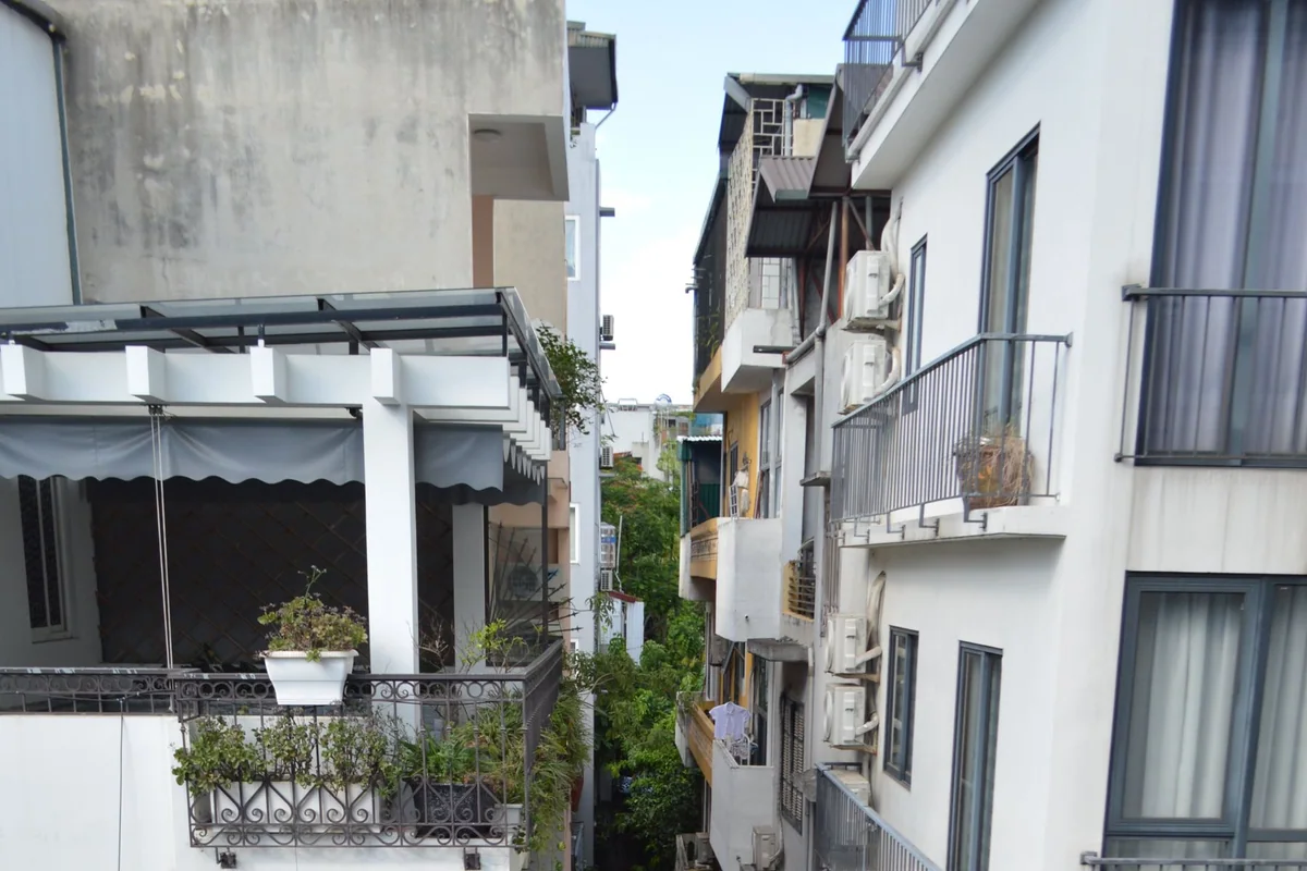A folding bistro set tucked beside a balcony railing