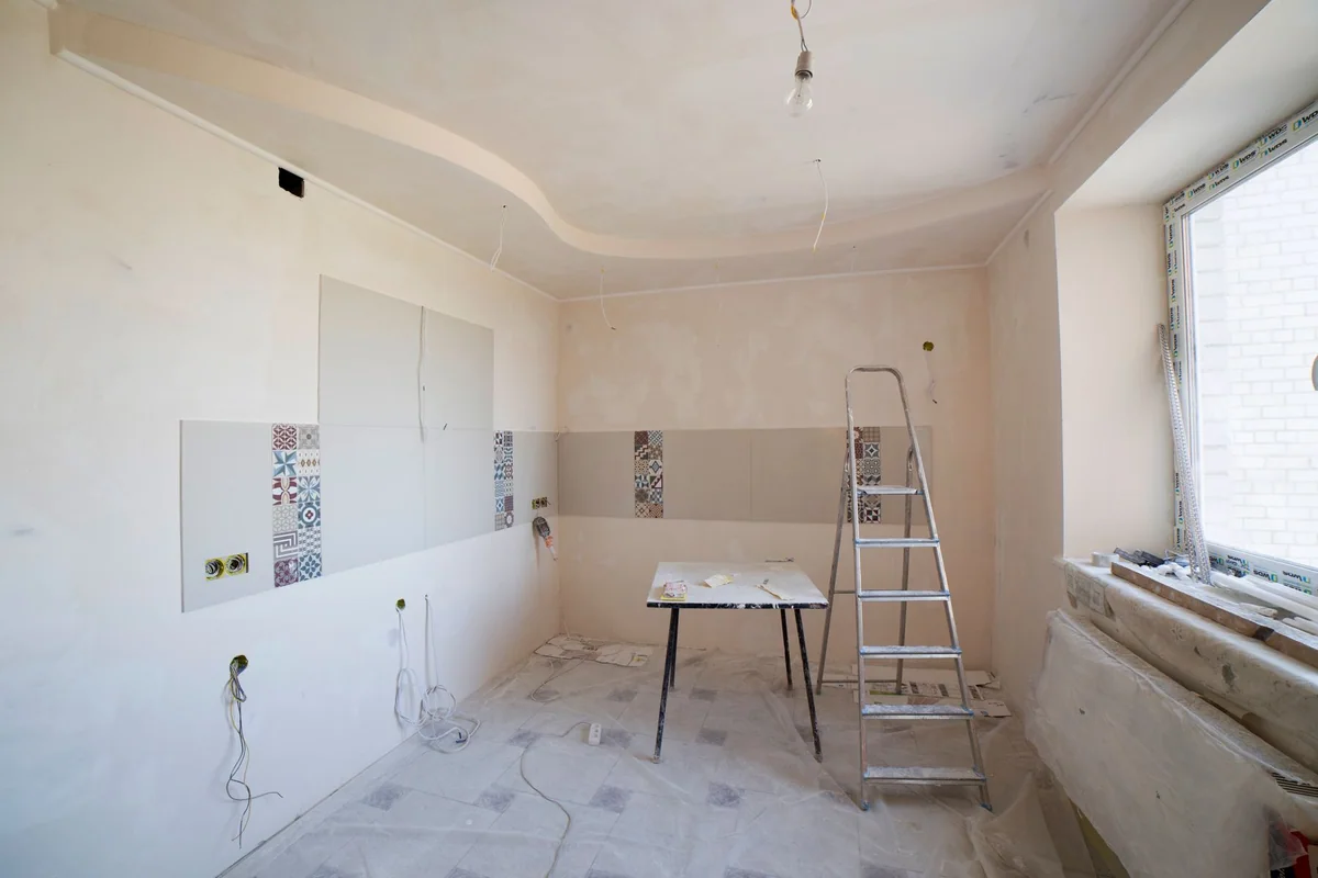 A person checking stool height against a kitchen counter overhang