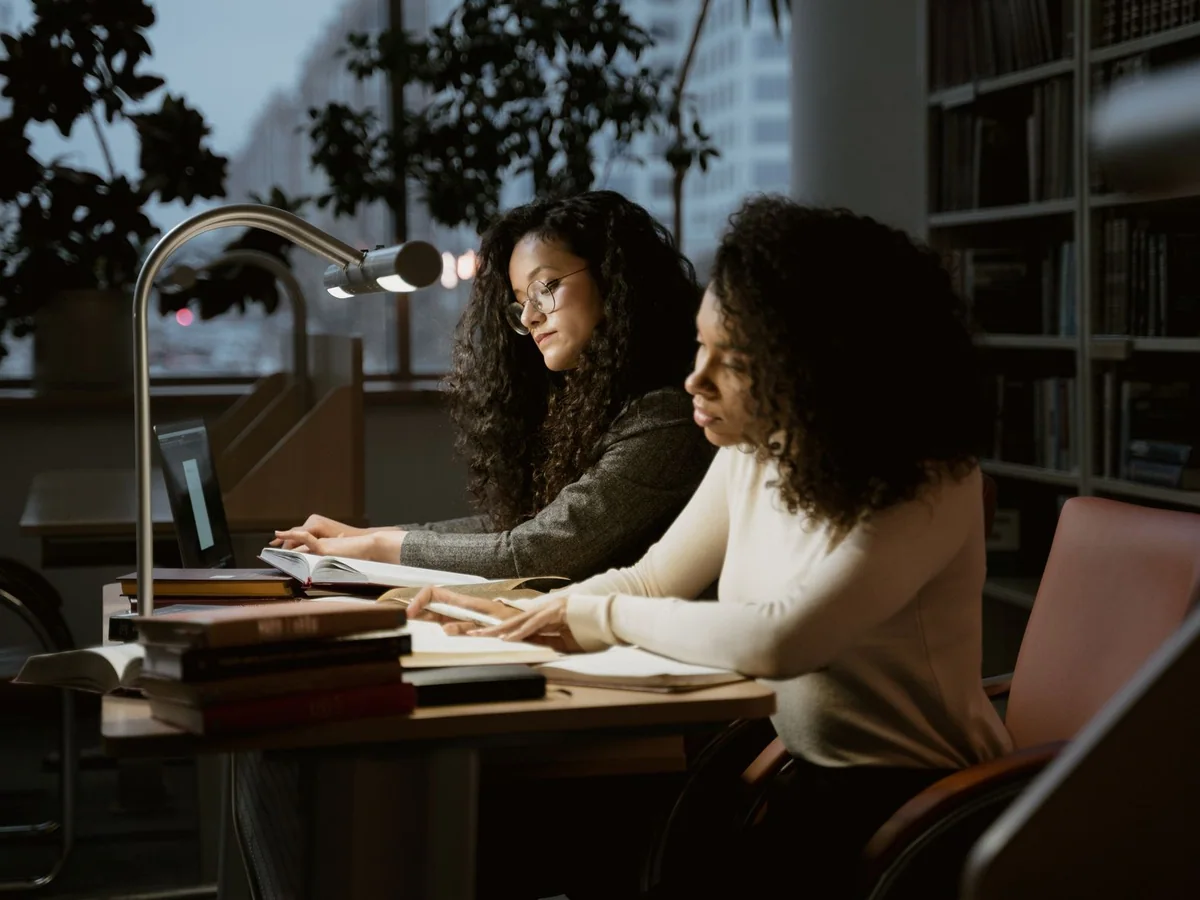 A low-glare desk lamp illuminating an evening home office