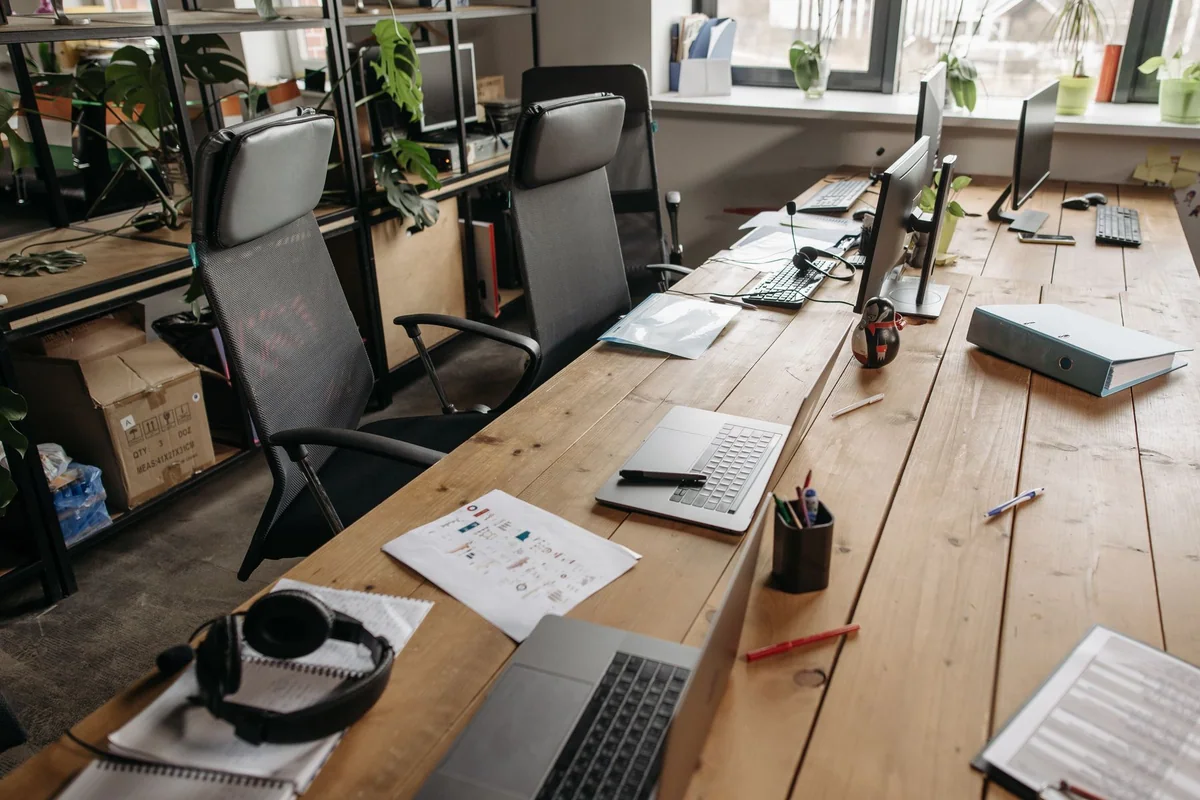 An adjustable office chair and footrest aligned at a desk