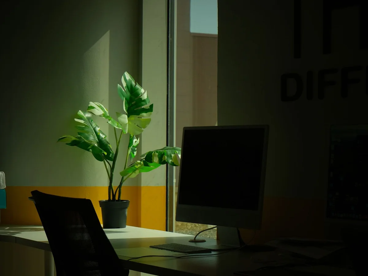 A small footrest beneath a home office desk