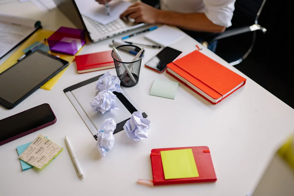 Receipts and envelopes organized vertically in a small workspace